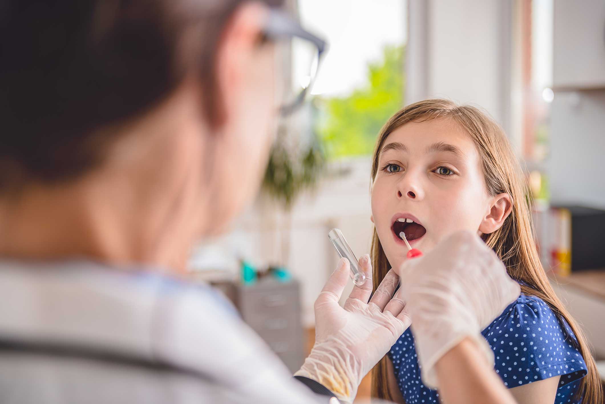 Doctor examining a patient's mouth